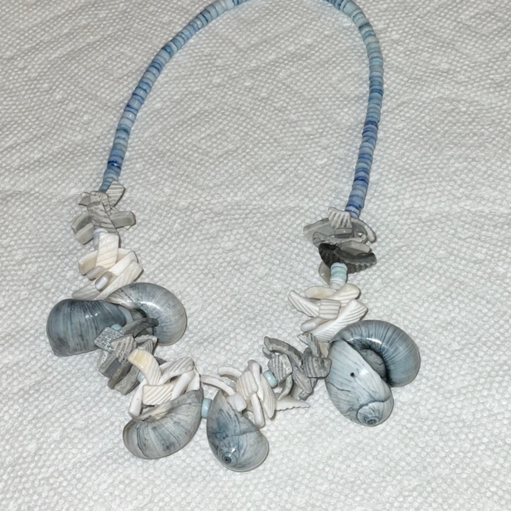 Bluish gray shell necklace. 18 inches in length. Like new!